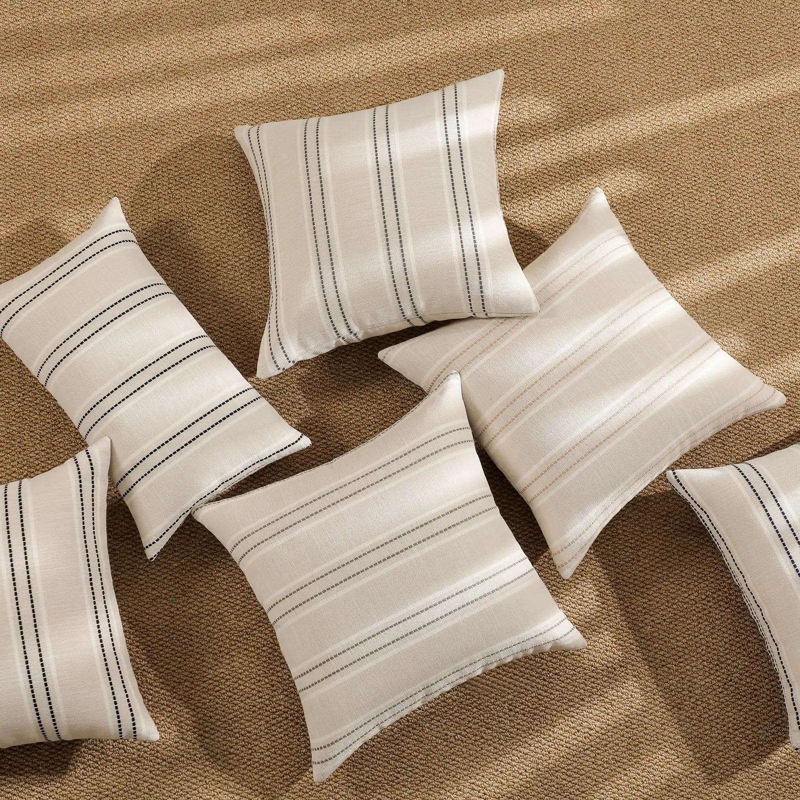 Set of striped pillows on a textured surface