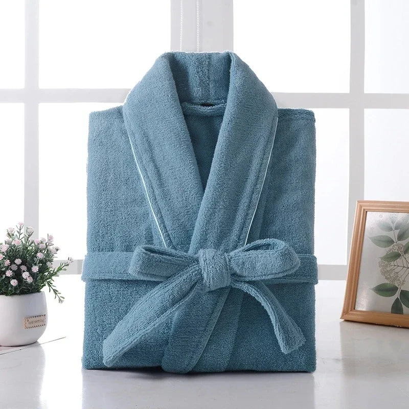 Folded blue robe on a white surface with a window in the background