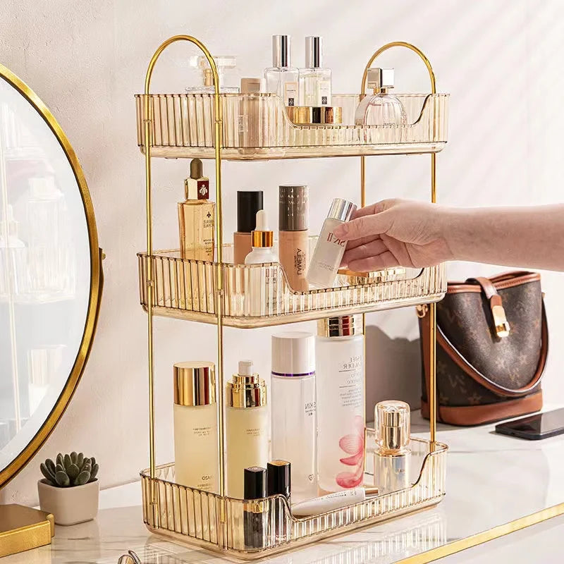 Gold three-tiered organizer with skincare products on a vanity table.