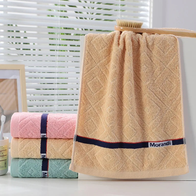 Beige towel with 'Morandi' branding on a white surface with a blurred background