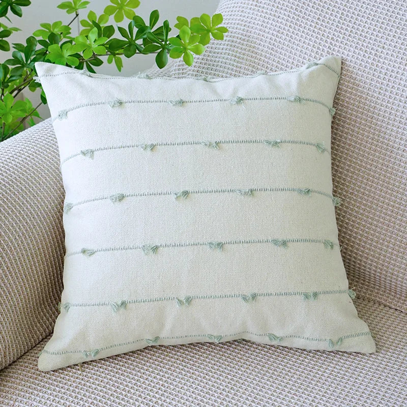 Decorative pillow with subtle pattern on a textured surface