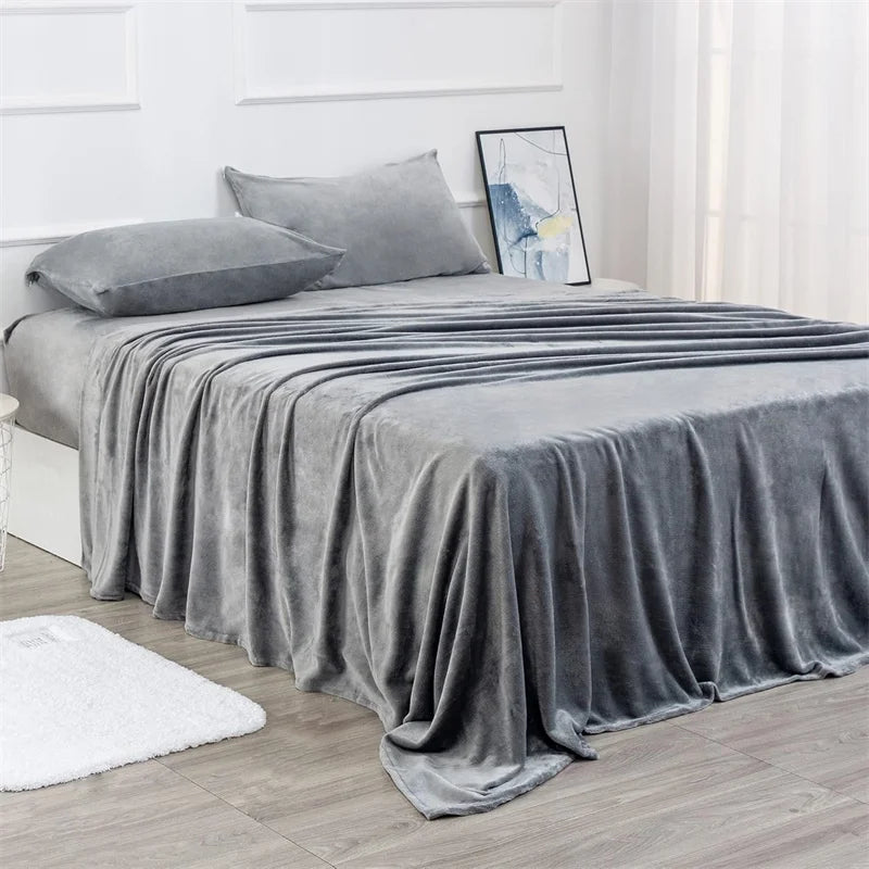 Gray bedspread on a bed in a bedroom setting