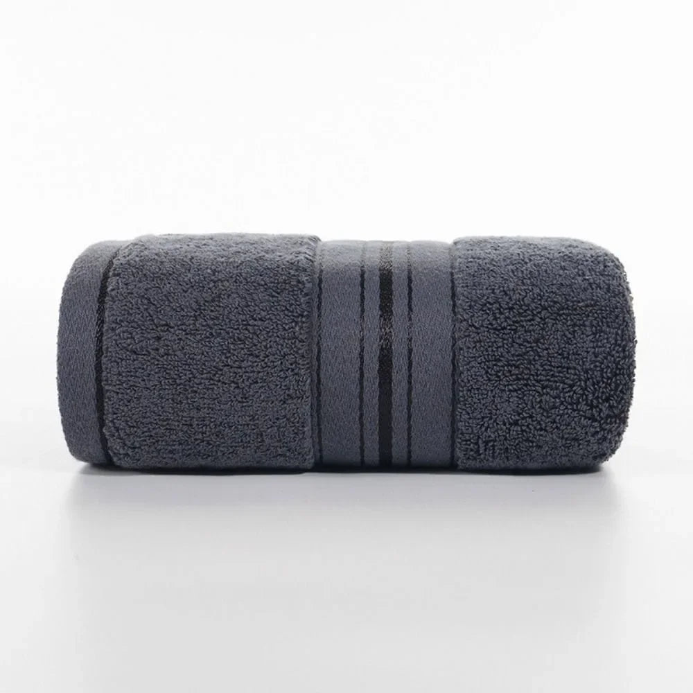 Rolled-up dark gray towel on a white background