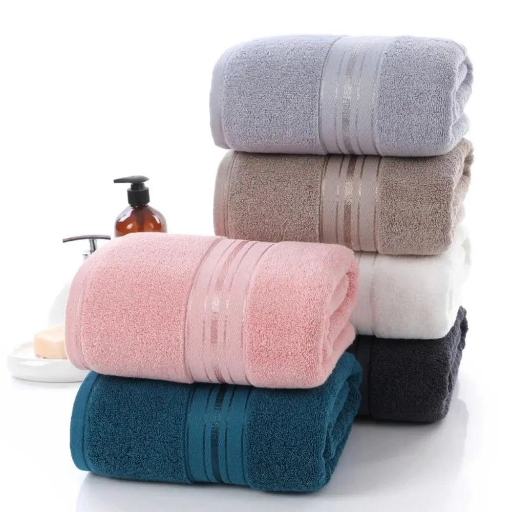 Stack of folded towels in various colors on a white background