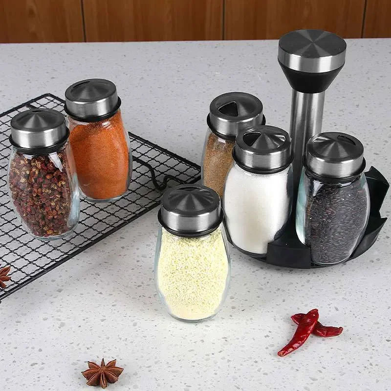 Set of spice jars with metal lids on a kitchen counter