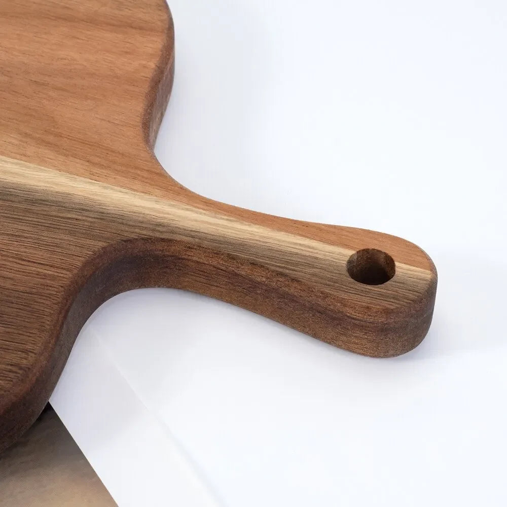 Wooden cutting board with handle on a white background