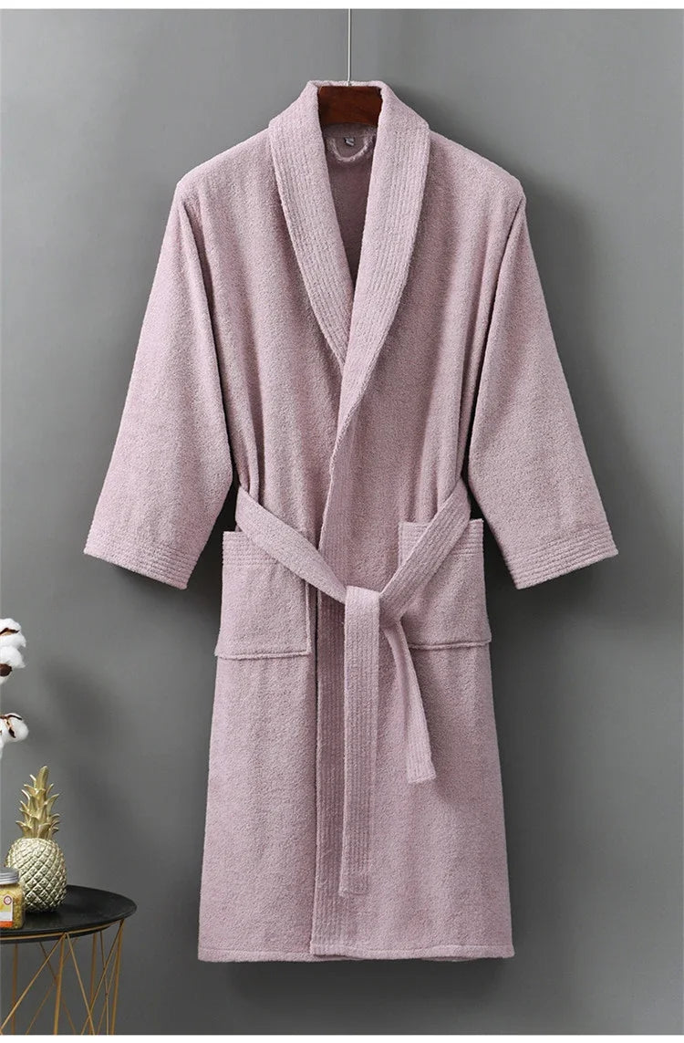 Pink bathrobe hanging against a gray background