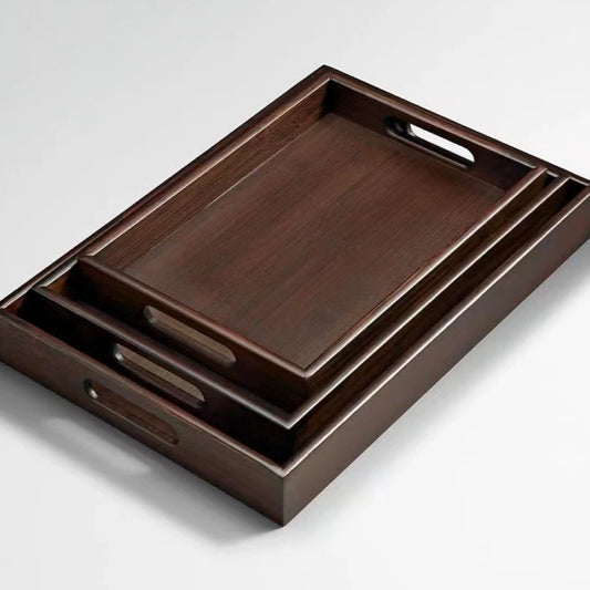 Set of wooden trays with handles on a light gray background