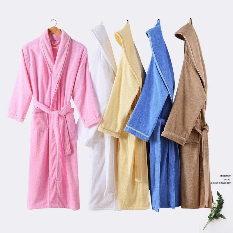 Five bathrobes in different colors hanging on a white background