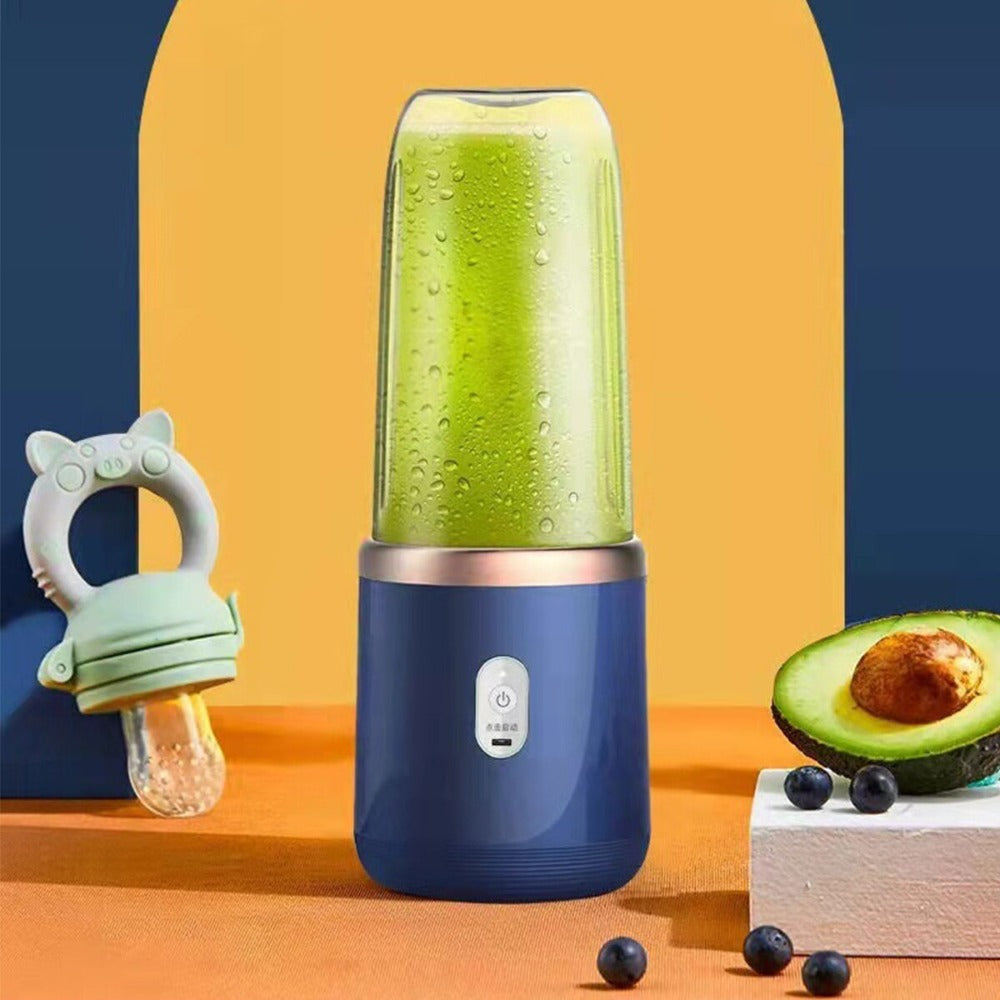 Blue portable blender with green juice, baby teether, and avocado on a colorful background