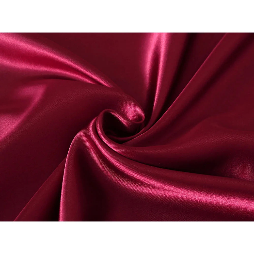 Close-up of red satin fabric with folds