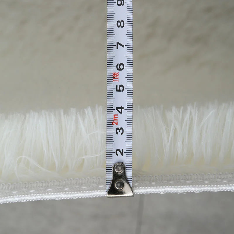 Measurements of a white lace trim with a ruler on a neutral background