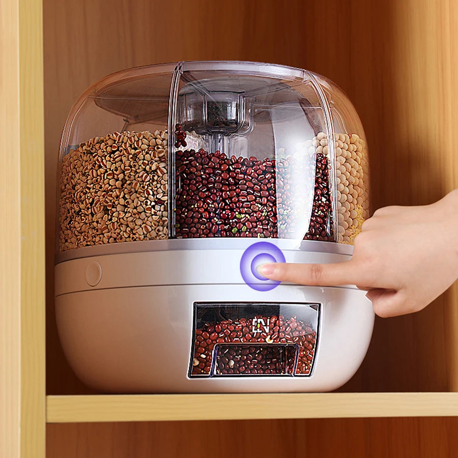 Hand pressing a button on a pet food dispenser filled with various grains.