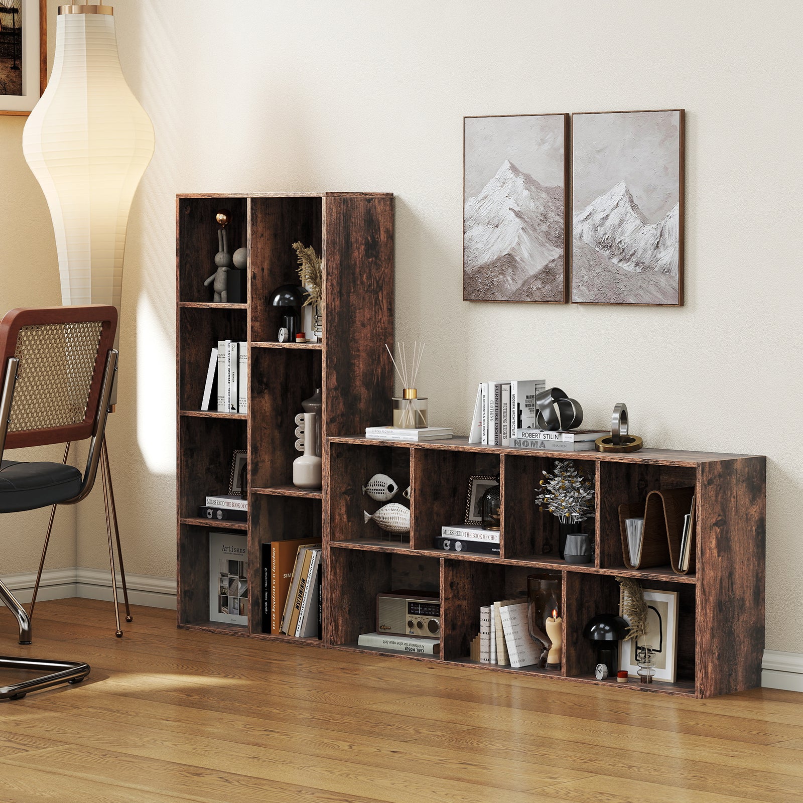 Wooden bookshelf with decorative items in a room with a lamp and wall art.