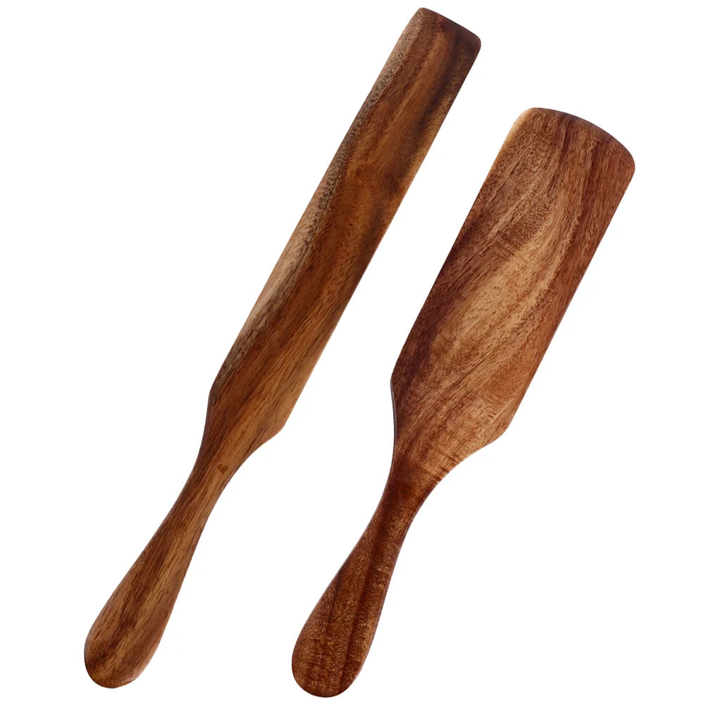 Two wooden paddles on a white background