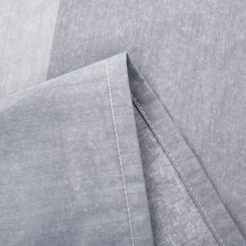 Close-up of gray fabric with a focus on texture and stitching.