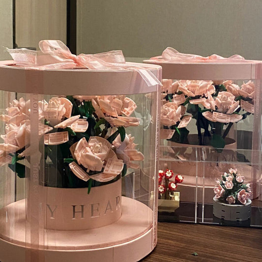 Decorative display with pink flowers and 'My Heart' text on a stand.