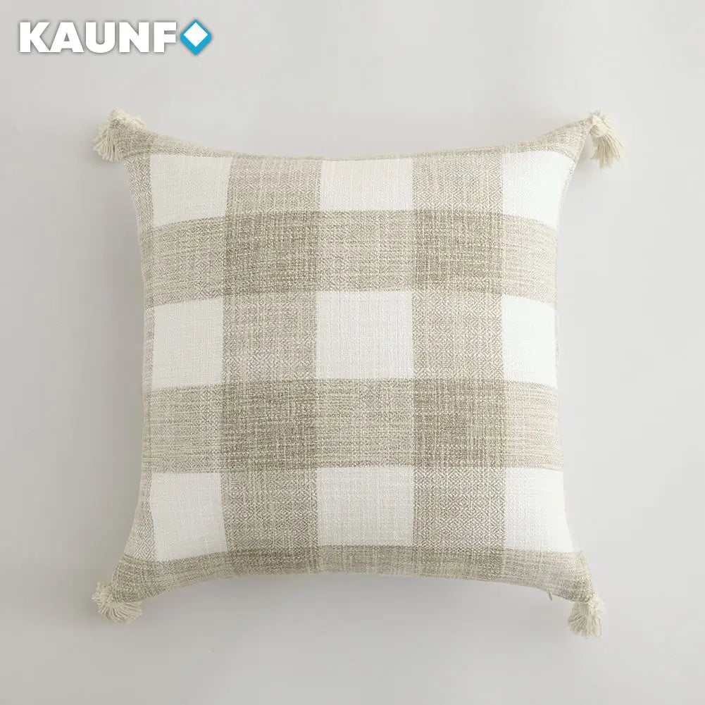 Plaid pillow with tassels on a white background, featuring the brand 'KAUNF'.