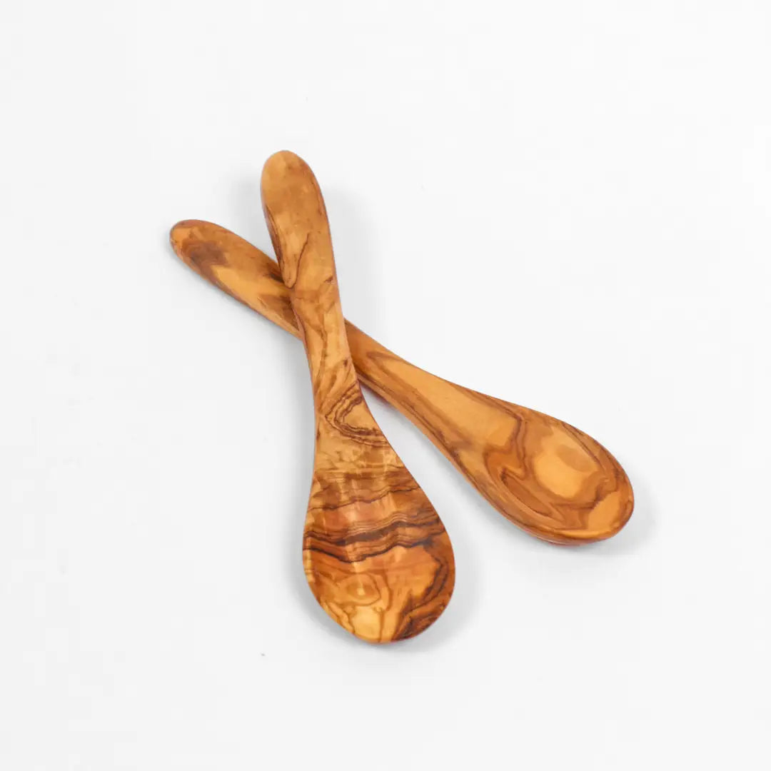 Two wooden spoons on a light gray background