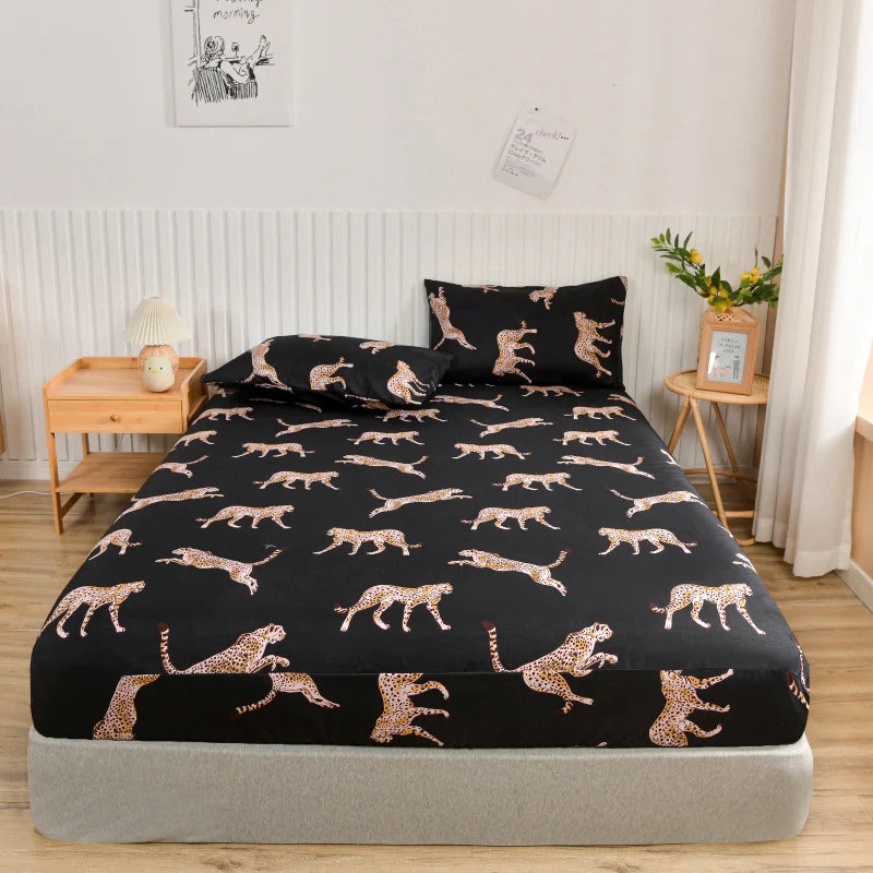 Bed with black fitted sheet featuring animal pattern in a bedroom setting