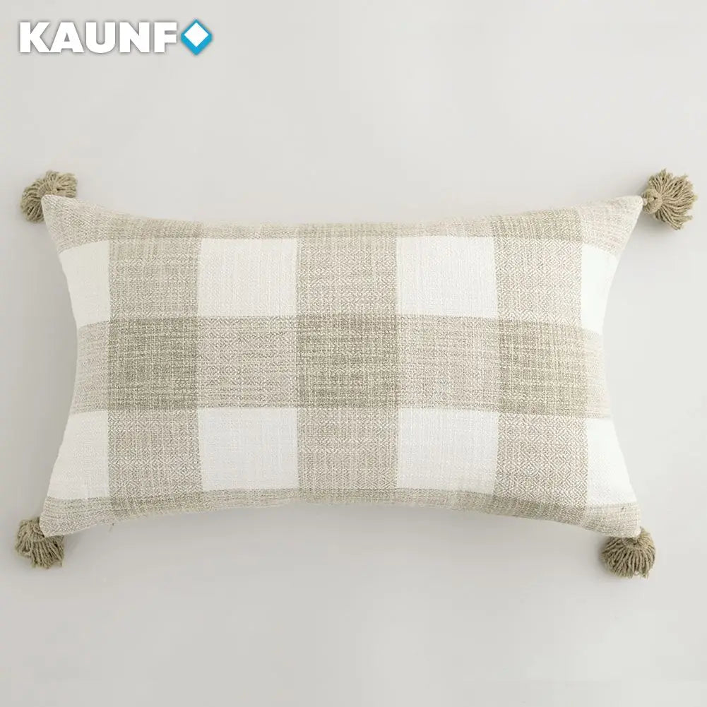 Plaid pillow with tassels on a white background, featuring the brand 'KAUNF'.