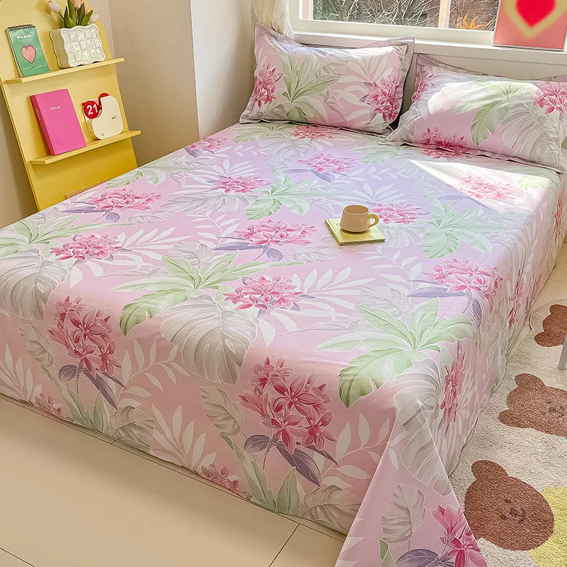 Floral patterned bedspread on a bed with a window and shelf in the background