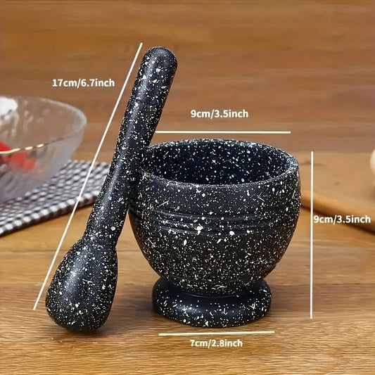 Black speckled mortar and pestle with measurements on a wooden surface
