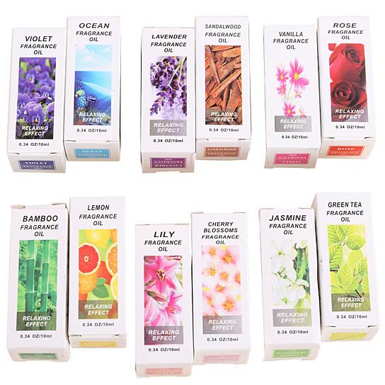Collection of various fragrance oil boxes with different scents on a white background