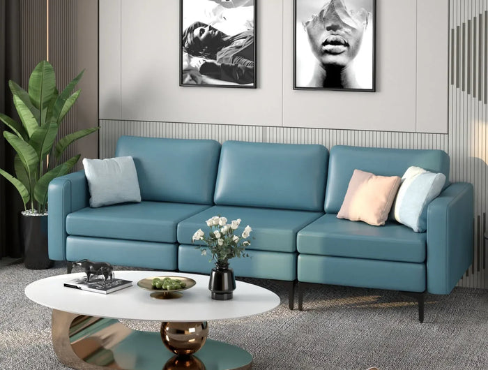 Modern living room with a blue sofa, coffee table, and decorative items.