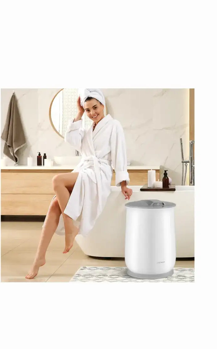 White cylindrical towel dryer with a black lid and silver base